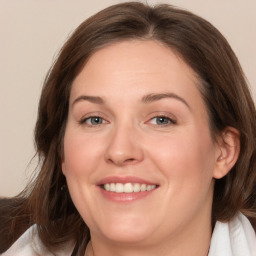 Joyful white adult female with medium  brown hair and grey eyes