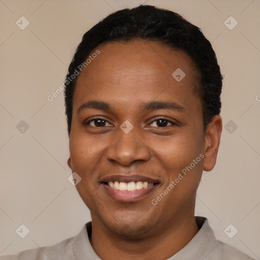 Joyful black young-adult male with short  black hair and brown eyes