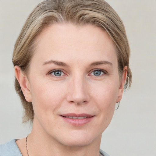 Joyful white young-adult female with short  brown hair and blue eyes