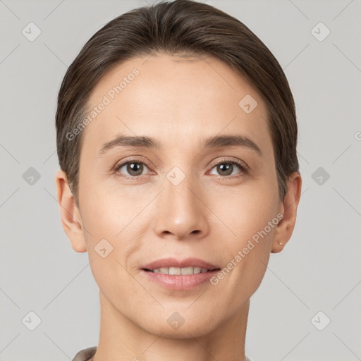 Joyful white young-adult female with short  brown hair and brown eyes