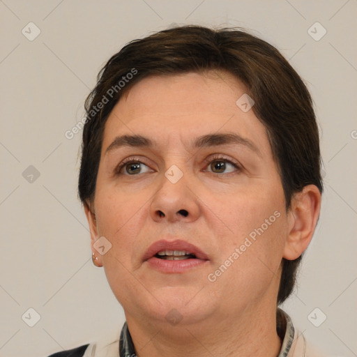 Joyful white adult female with short  brown hair and brown eyes