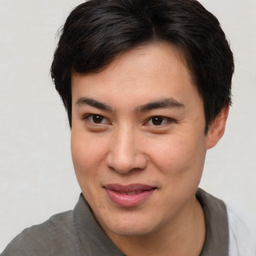 Joyful asian young-adult male with short  brown hair and brown eyes