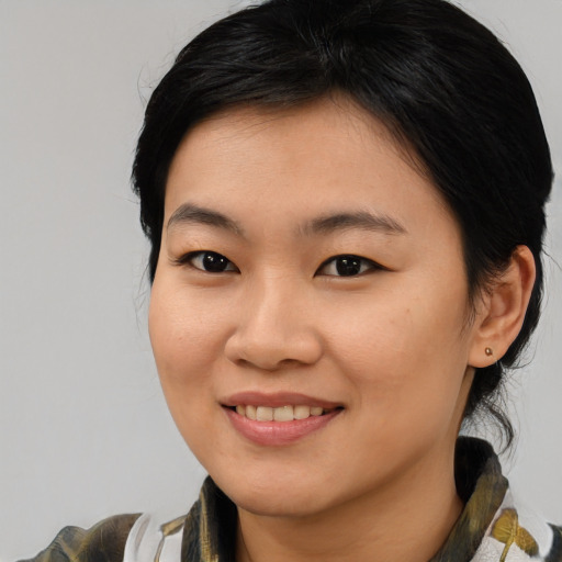 Joyful asian young-adult female with medium  brown hair and brown eyes