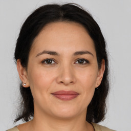 Joyful white adult female with medium  brown hair and brown eyes