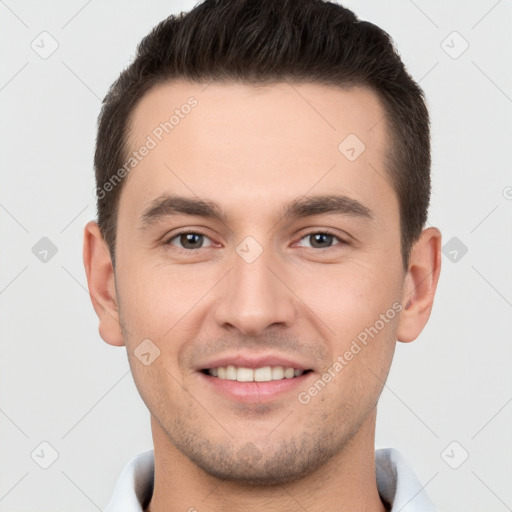 Joyful white young-adult male with short  brown hair and brown eyes