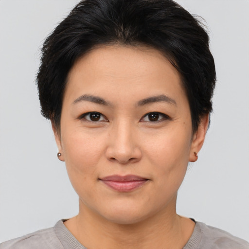 Joyful asian young-adult female with short  brown hair and brown eyes