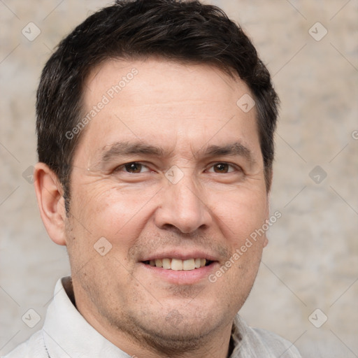 Joyful white adult male with short  brown hair and brown eyes