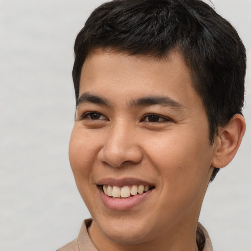 Joyful asian young-adult male with short  brown hair and brown eyes