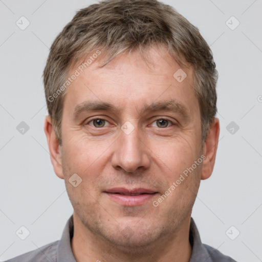 Joyful white adult male with short  brown hair and brown eyes