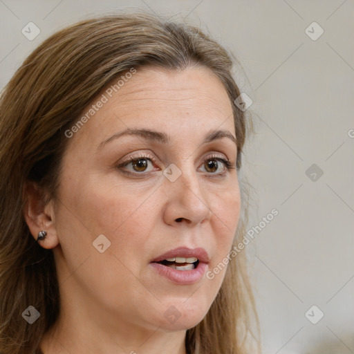 Joyful white adult female with long  brown hair and grey eyes