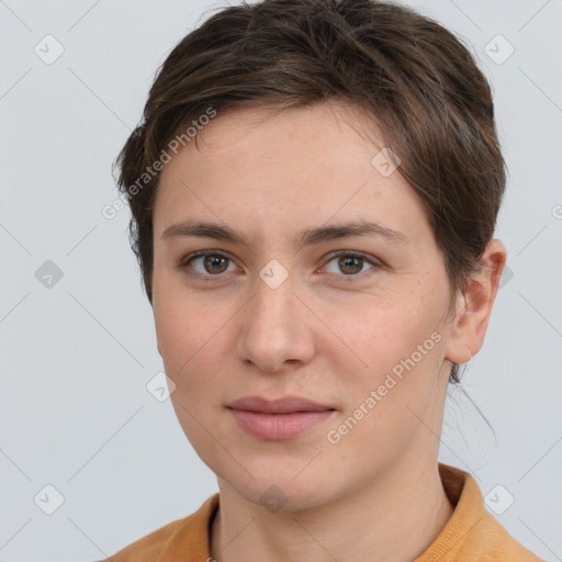 Joyful white young-adult female with short  brown hair and grey eyes