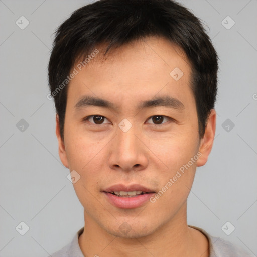 Joyful asian young-adult male with short  brown hair and brown eyes