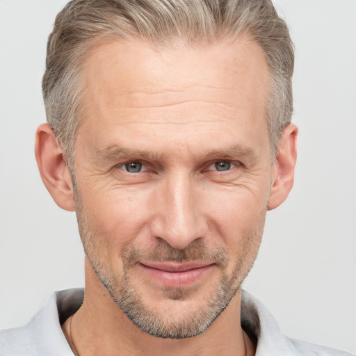 Joyful white middle-aged male with short  brown hair and brown eyes