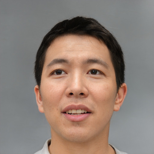 Joyful asian young-adult male with short  brown hair and brown eyes