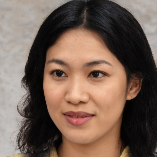 Joyful asian young-adult female with medium  black hair and brown eyes
