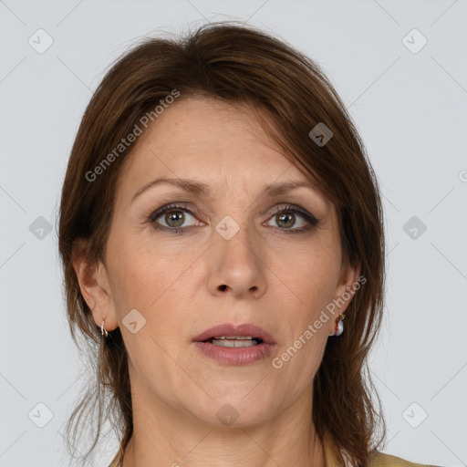 Joyful white adult female with medium  brown hair and grey eyes