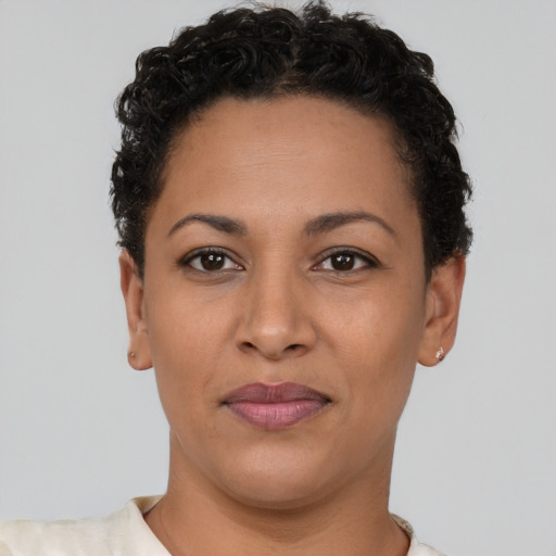 Joyful latino young-adult female with short  brown hair and brown eyes