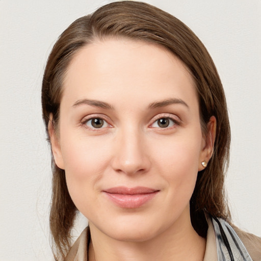 Joyful white young-adult female with long  brown hair and grey eyes