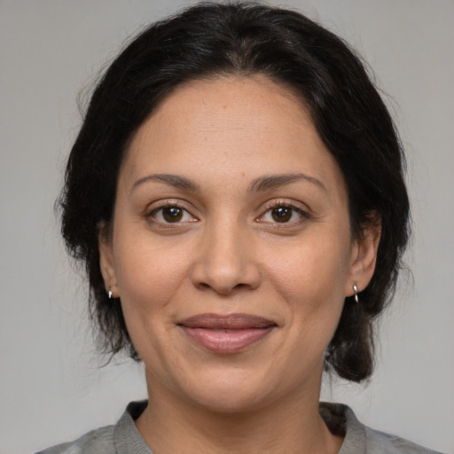 Joyful white adult female with medium  brown hair and brown eyes