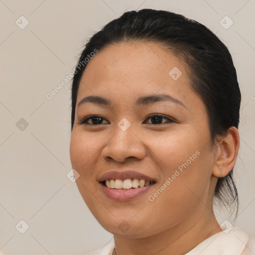 Joyful latino young-adult female with medium  brown hair and brown eyes