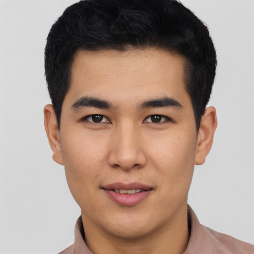 Joyful asian young-adult male with short  black hair and brown eyes