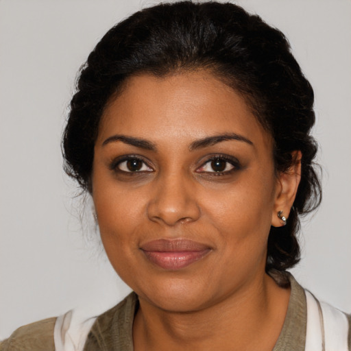 Joyful black young-adult female with medium  brown hair and brown eyes