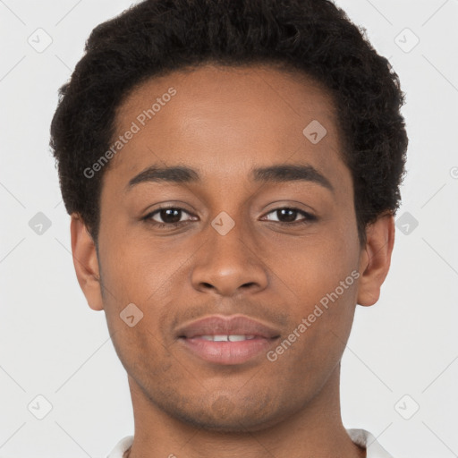 Joyful black young-adult male with short  brown hair and brown eyes