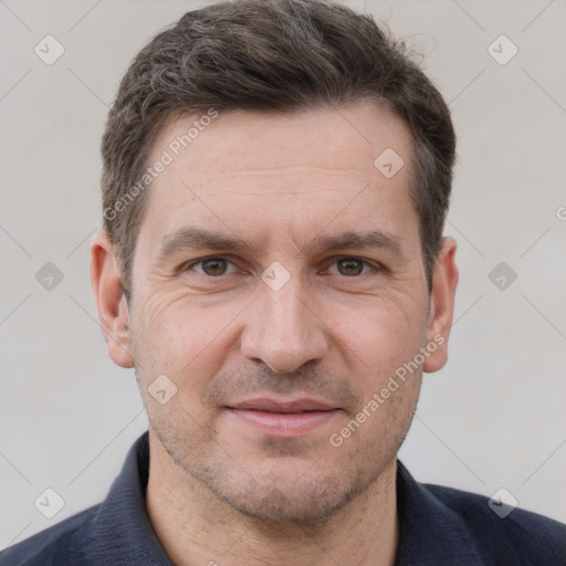 Joyful white adult male with short  brown hair and grey eyes