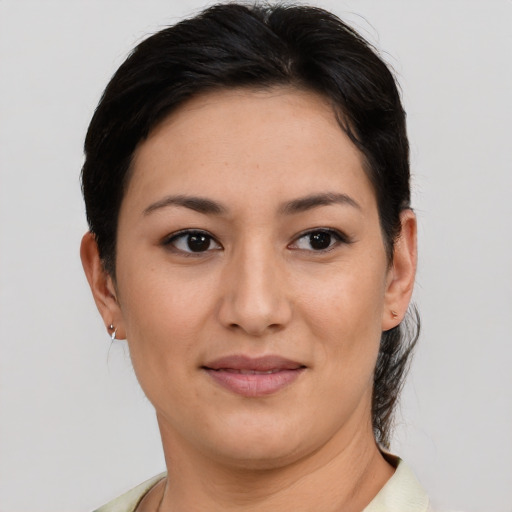 Joyful asian young-adult female with short  brown hair and brown eyes
