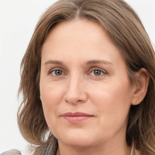 Joyful white adult female with long  brown hair and brown eyes