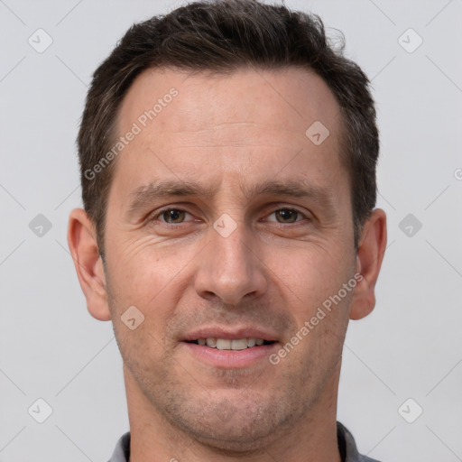 Joyful white adult male with short  brown hair and brown eyes