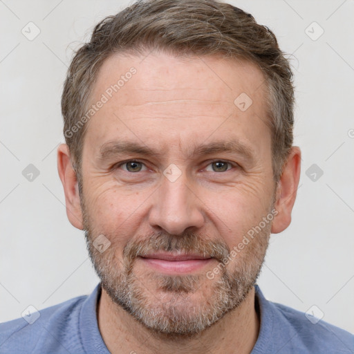 Joyful white adult male with short  brown hair and grey eyes