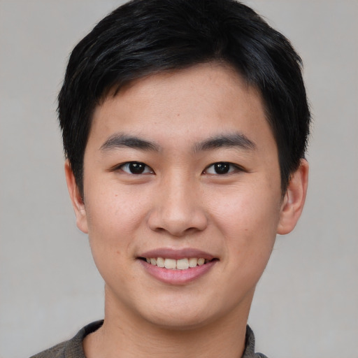 Joyful asian young-adult male with short  black hair and brown eyes