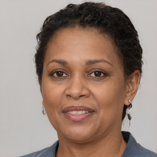 Joyful black adult female with short  brown hair and brown eyes