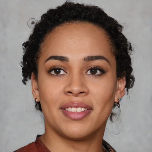 Joyful black young-adult female with medium  brown hair and brown eyes