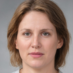 Joyful white adult female with medium  brown hair and grey eyes