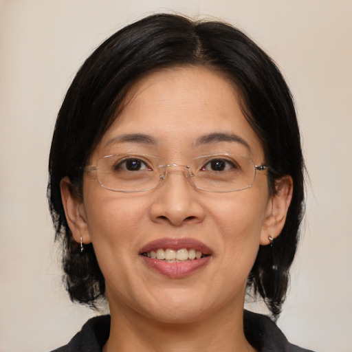 Joyful asian adult female with medium  brown hair and brown eyes