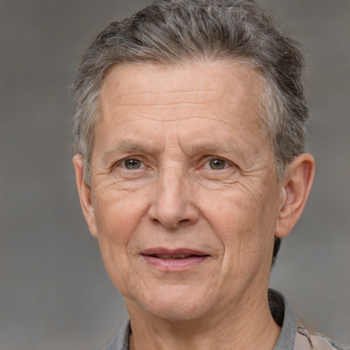 Joyful white middle-aged male with short  gray hair and brown eyes