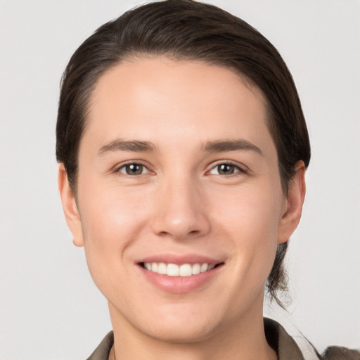 Joyful white young-adult female with short  brown hair and brown eyes