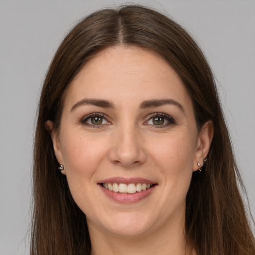 Joyful white young-adult female with long  brown hair and grey eyes