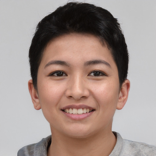 Joyful asian young-adult female with short  brown hair and brown eyes