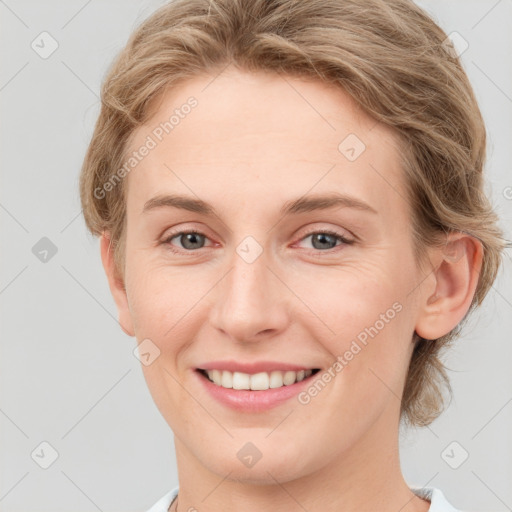 Joyful white young-adult female with medium  brown hair and blue eyes