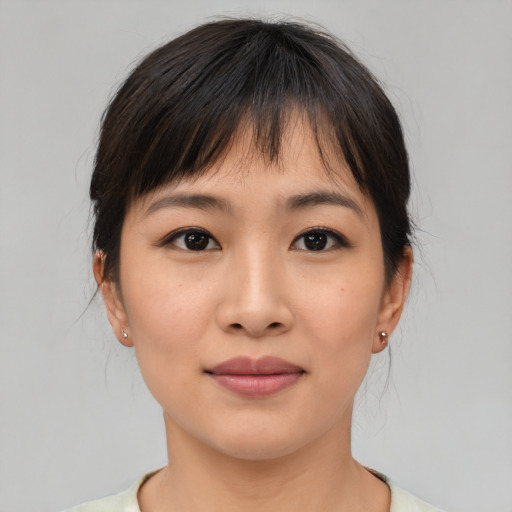 Joyful asian young-adult female with medium  brown hair and brown eyes