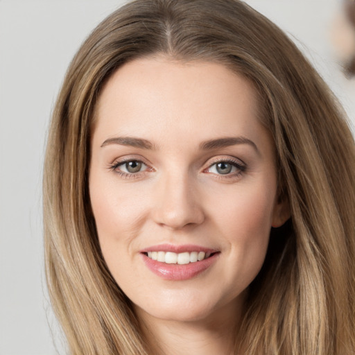 Joyful white young-adult female with long  brown hair and grey eyes