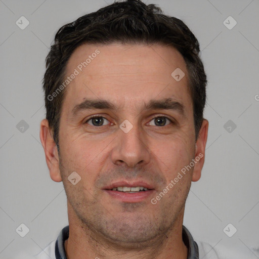 Joyful white adult male with short  brown hair and brown eyes