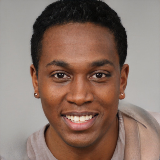Joyful black young-adult male with short  black hair and brown eyes