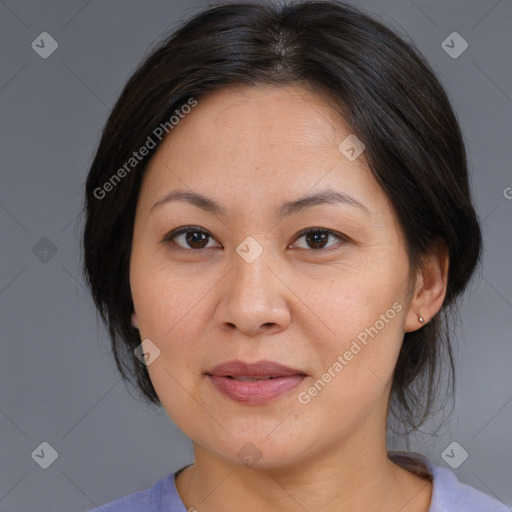 Joyful asian adult female with medium  brown hair and brown eyes