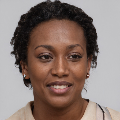 Joyful black young-adult female with short  brown hair and brown eyes