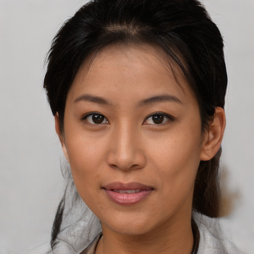 Joyful asian young-adult female with medium  brown hair and brown eyes