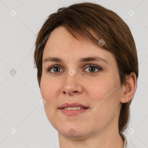 Joyful white young-adult female with medium  brown hair and grey eyes